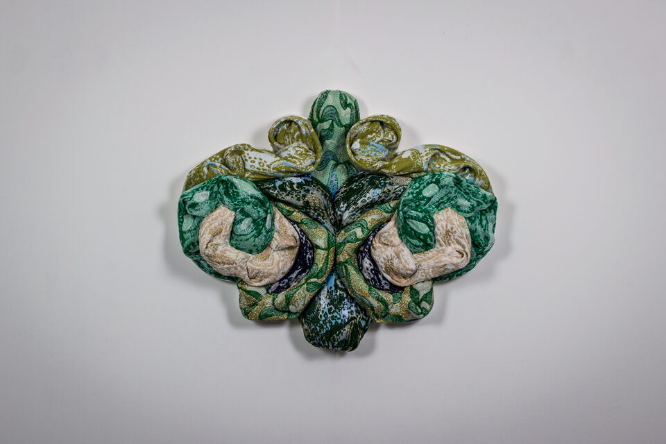 Emerald in spotlight, luminous in green and golden-yellow tones.
