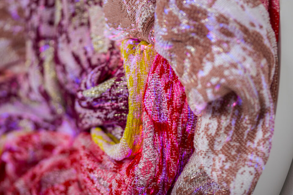Detail shot of Ruby's dense weave in deep red and rose.