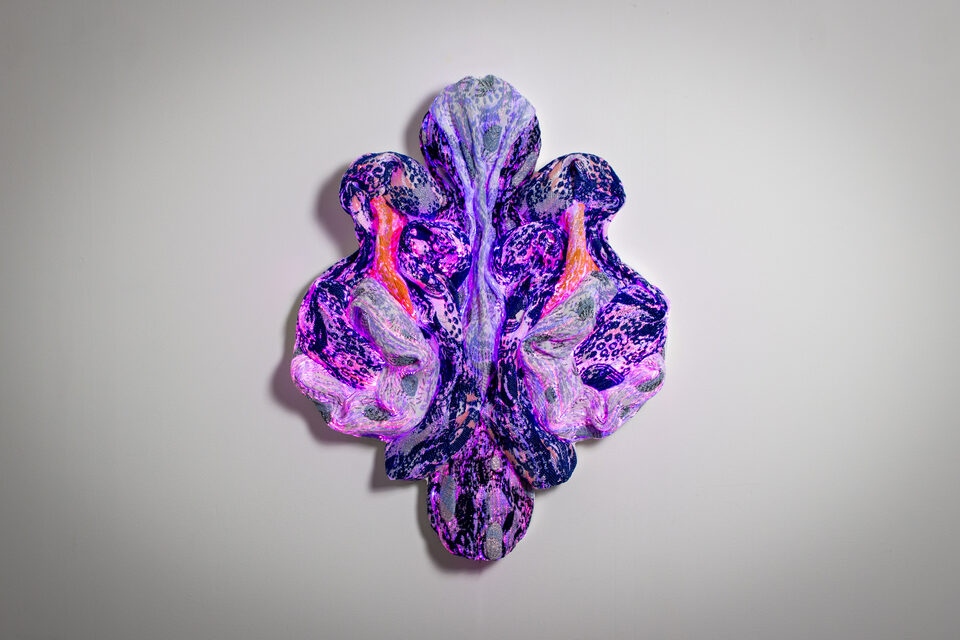 Sapphire in ambient light, soft blue and violet tones against a white backdrop.